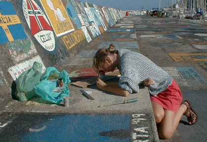 Nicky painting our name on the pier